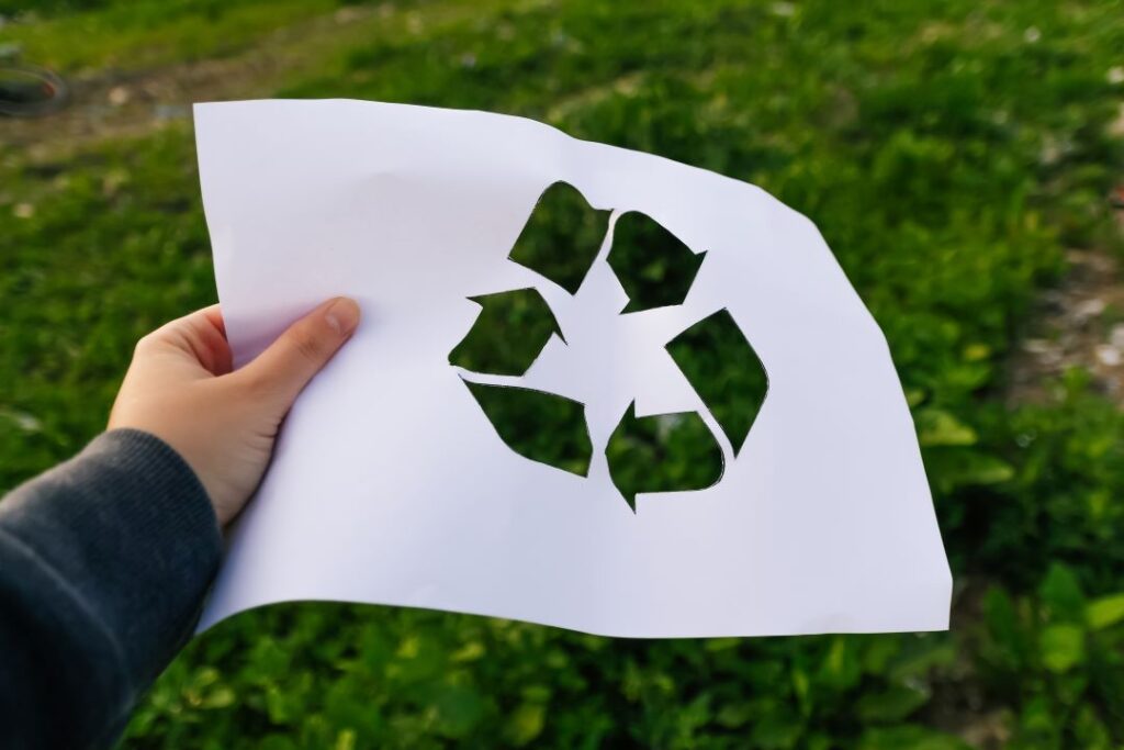 defocus-hand-holding-cut-paper-with-the-logo-of-gr-2023-11-27-05-23-55-utc